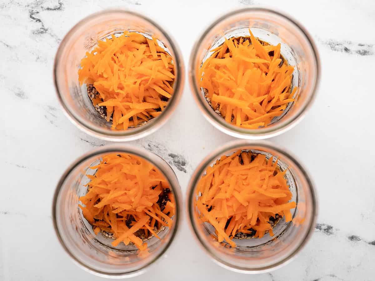 Shredded Carrots added to the jars.