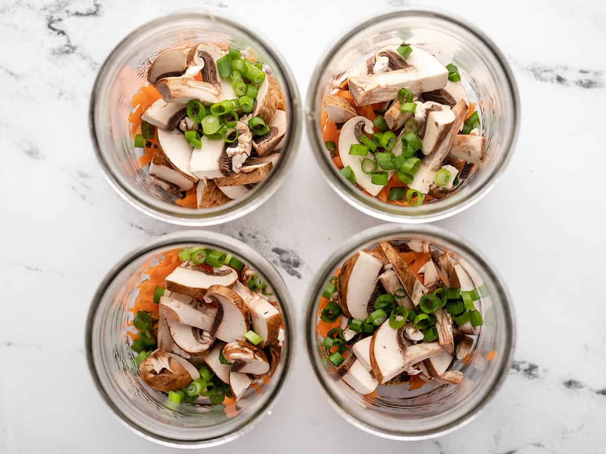 Mushrooms and green onion added to the jars.