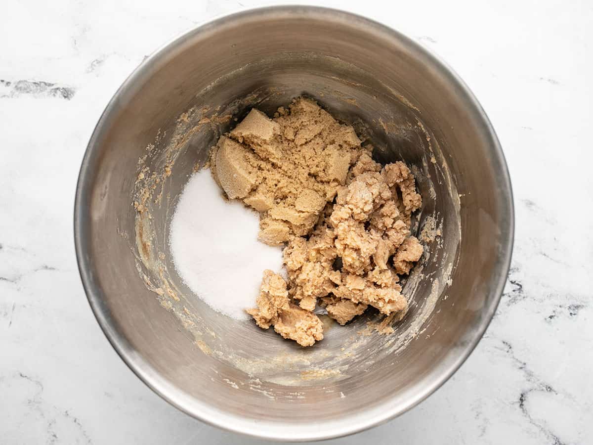 Overhead shot of brown and granulated sugar with chilled brown butter in a silver bowl.