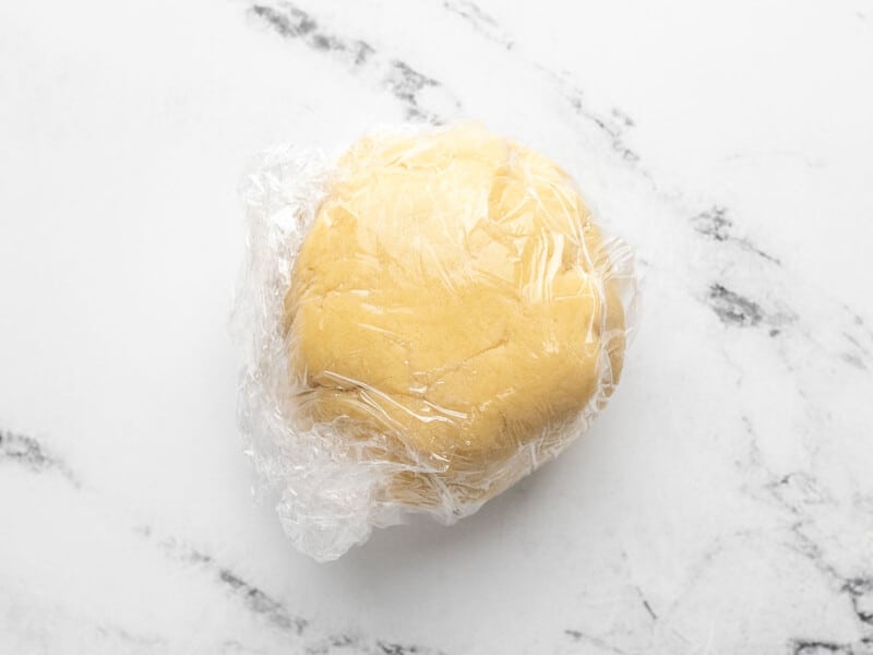 Dough wrapped in plastic.
