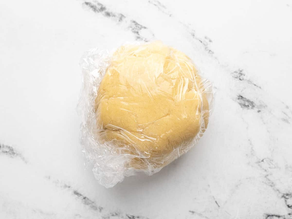 Wrap the dough in plastic after forming it into a ball. The dough should be chilled for 30 minutes.