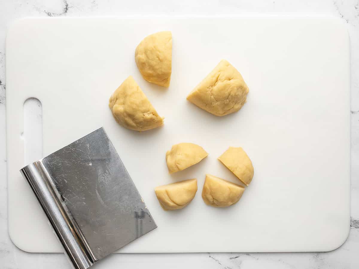 Dough being divided into 16 pieces.