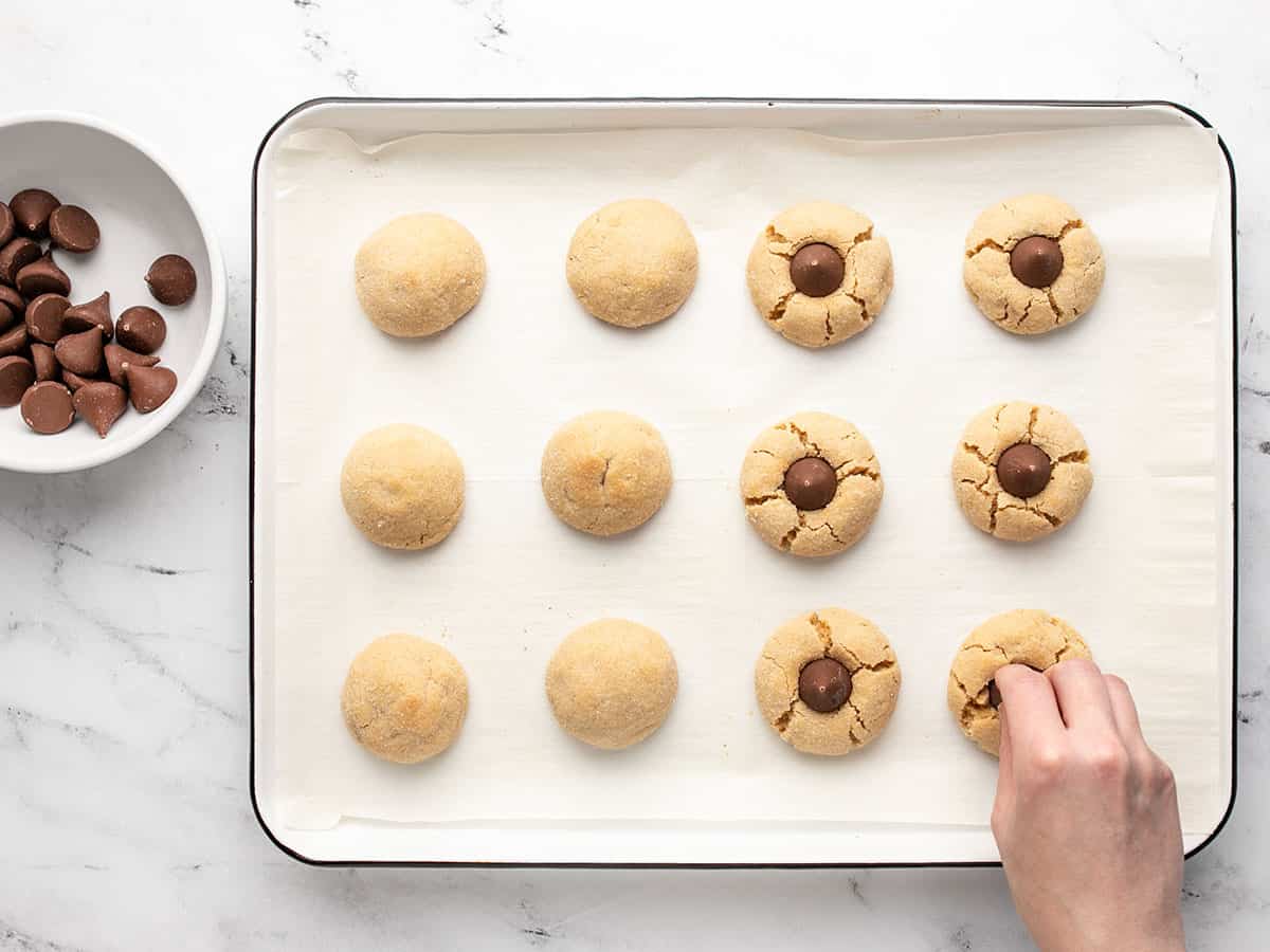 Kisses being pressed into the cookies.