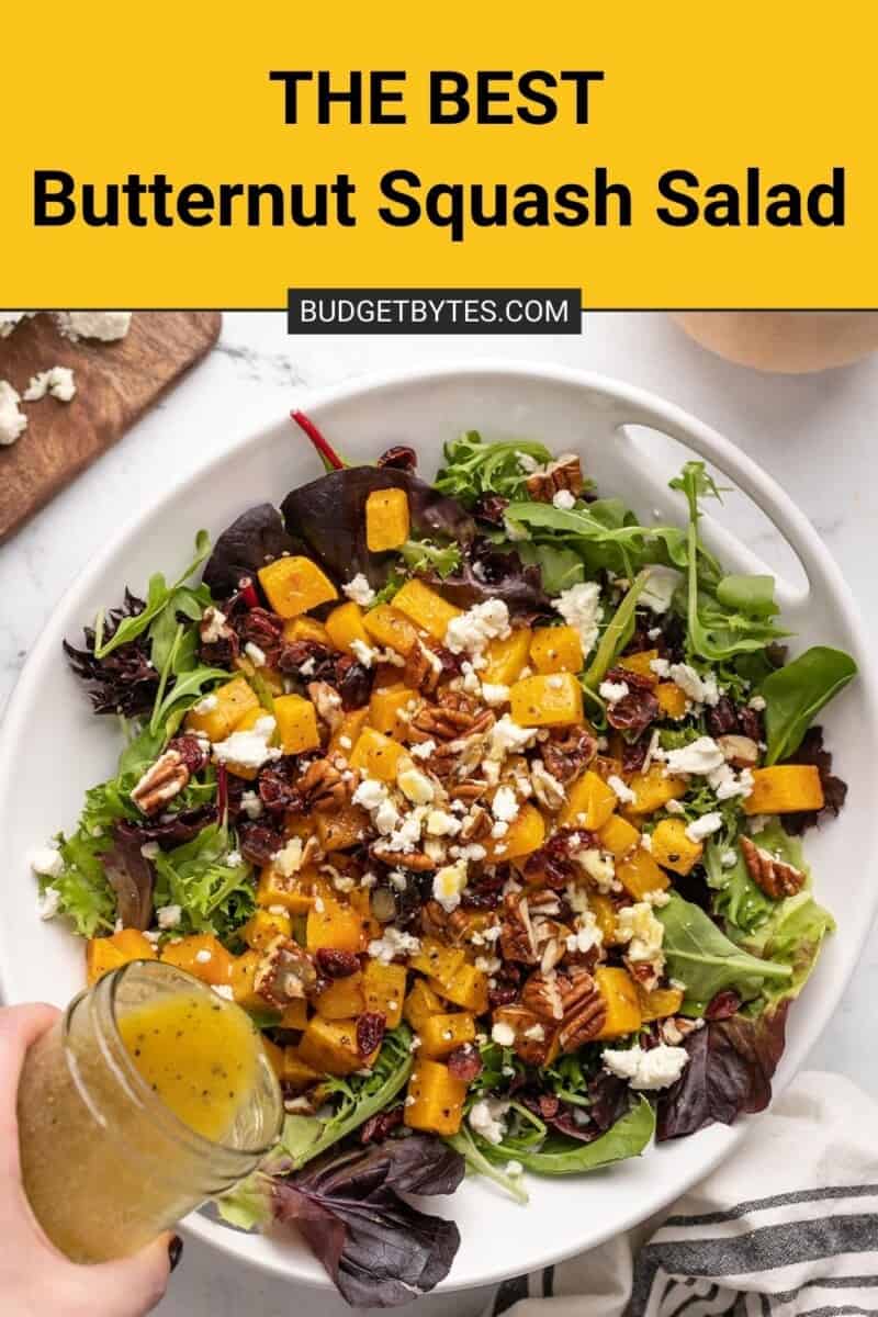 Dressing being poured onto butternut squash salad.