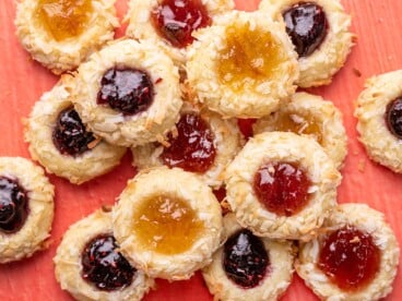 Overhead view of a pile of jam thumbprint cookies.
