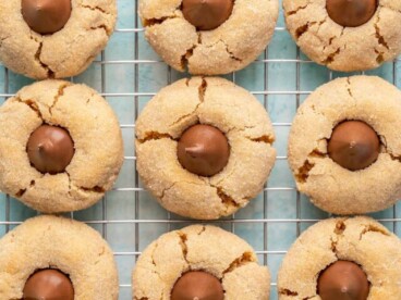 Overhead view of peanut butter blossom cookies on a wire cooling rack.