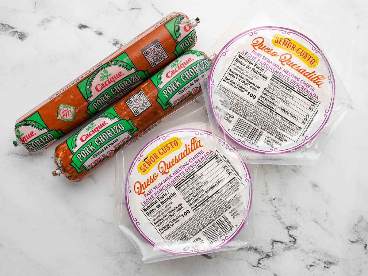 Overhead shot of chorizo and cheese in their [packaging on a counter top.