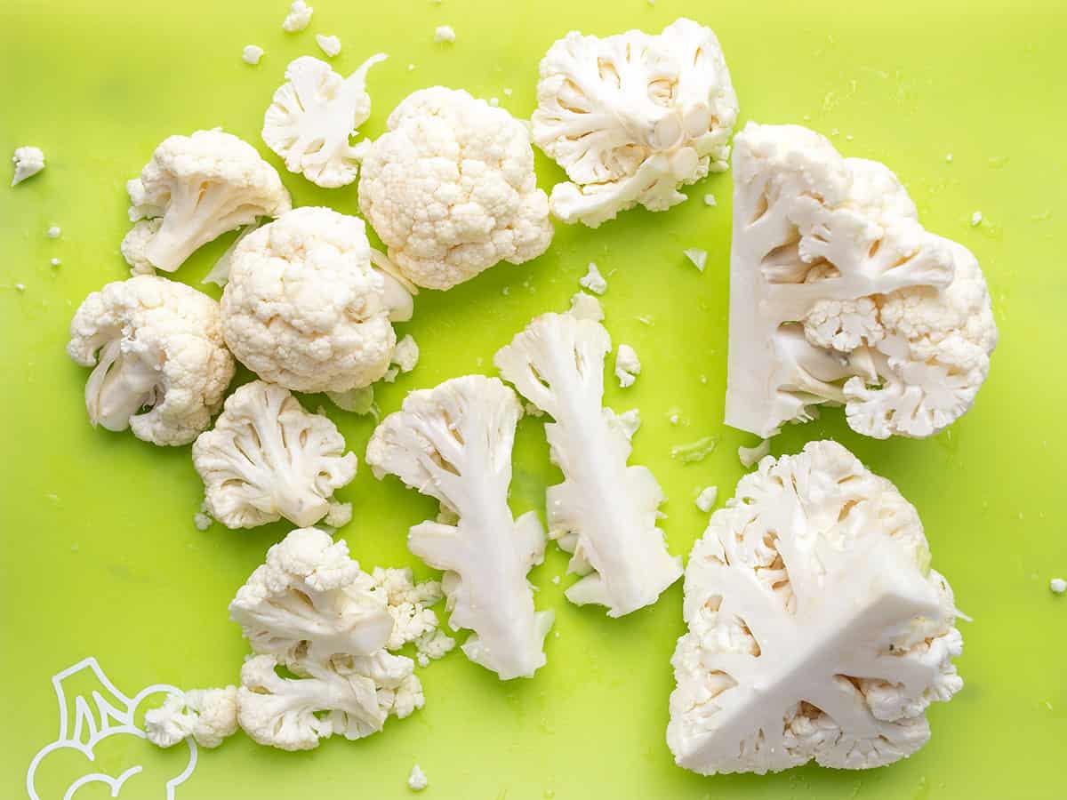 Cauliflower being cut into florets. 