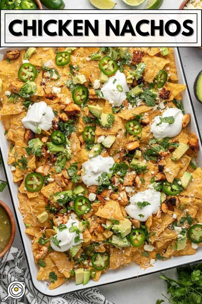 Overhead view of a sheet pan full of chicken nachos.