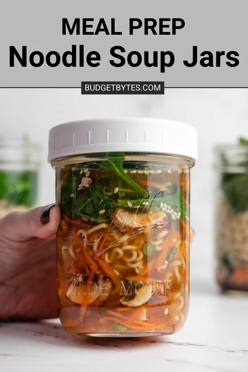 A hand holding a mixed noodle soup jar.