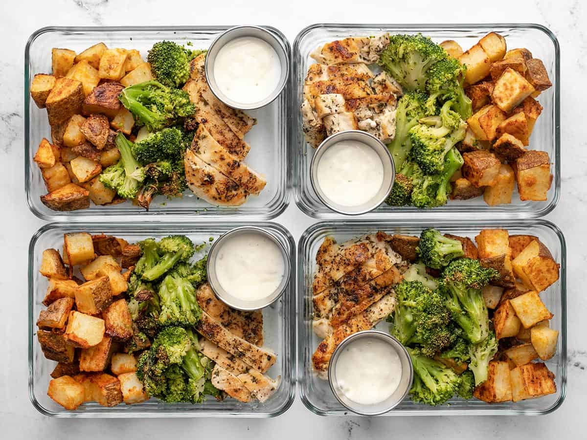 Four meal prep containers full of chicken, potatoes, and broccoli.