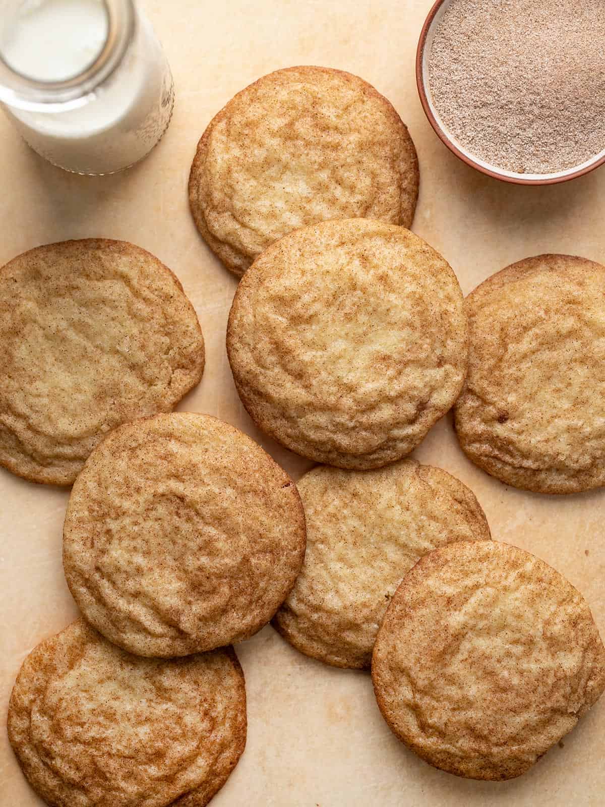 Overhead shot of snickerdoodles next to a glass of milk.
