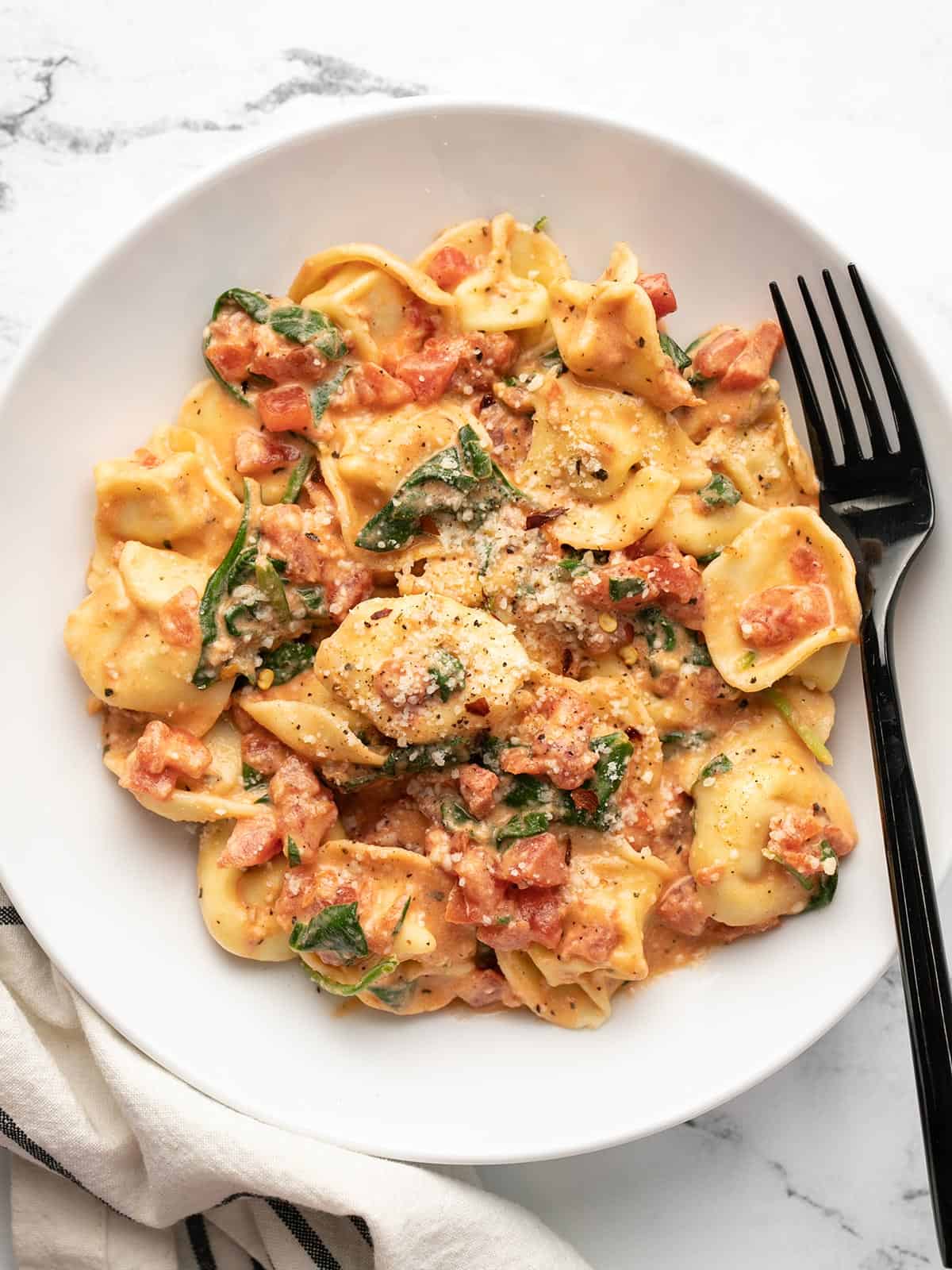 Close up overhead view of a bowl full of Spinach Tortellini.