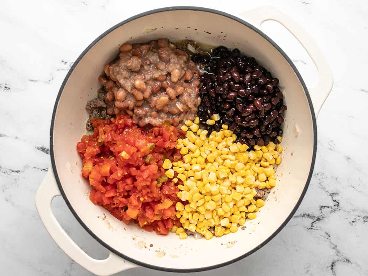 Beans, corn, and tomatoes in the pot.