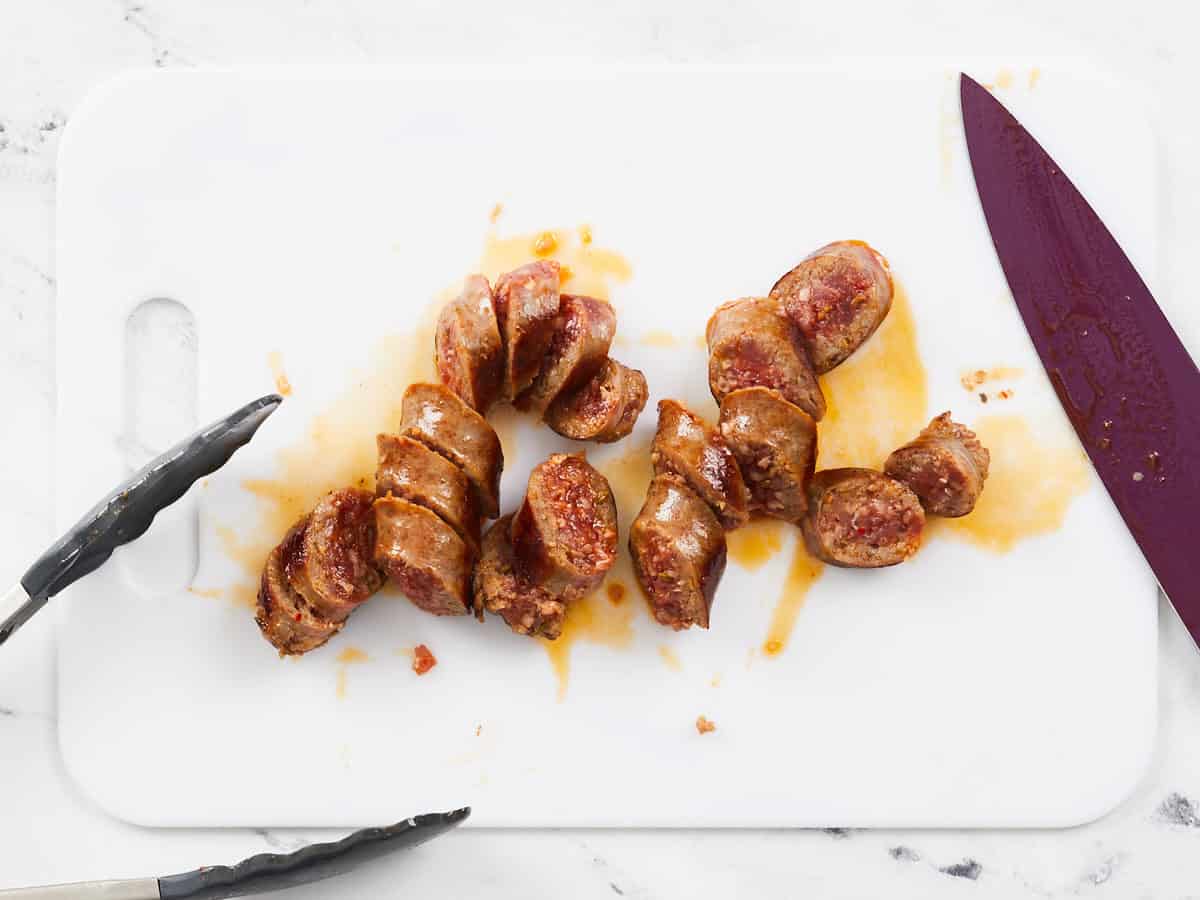 Sliced sausage on a cutting board.