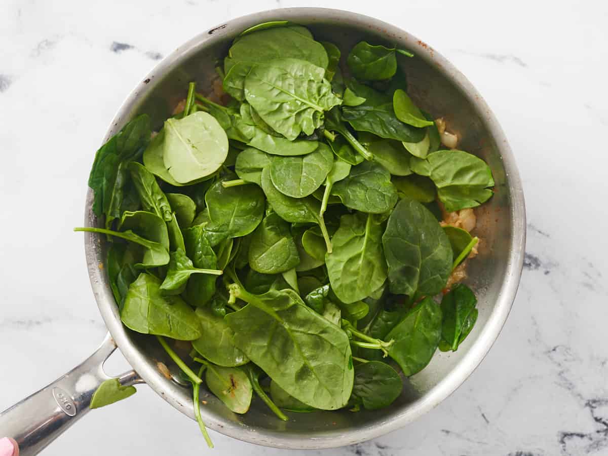 Overhead shot of spinach in a pot.