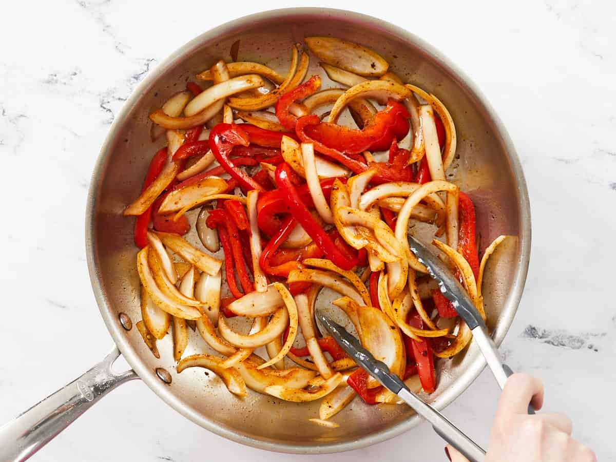 Cooked peppers and onions in the skillet.