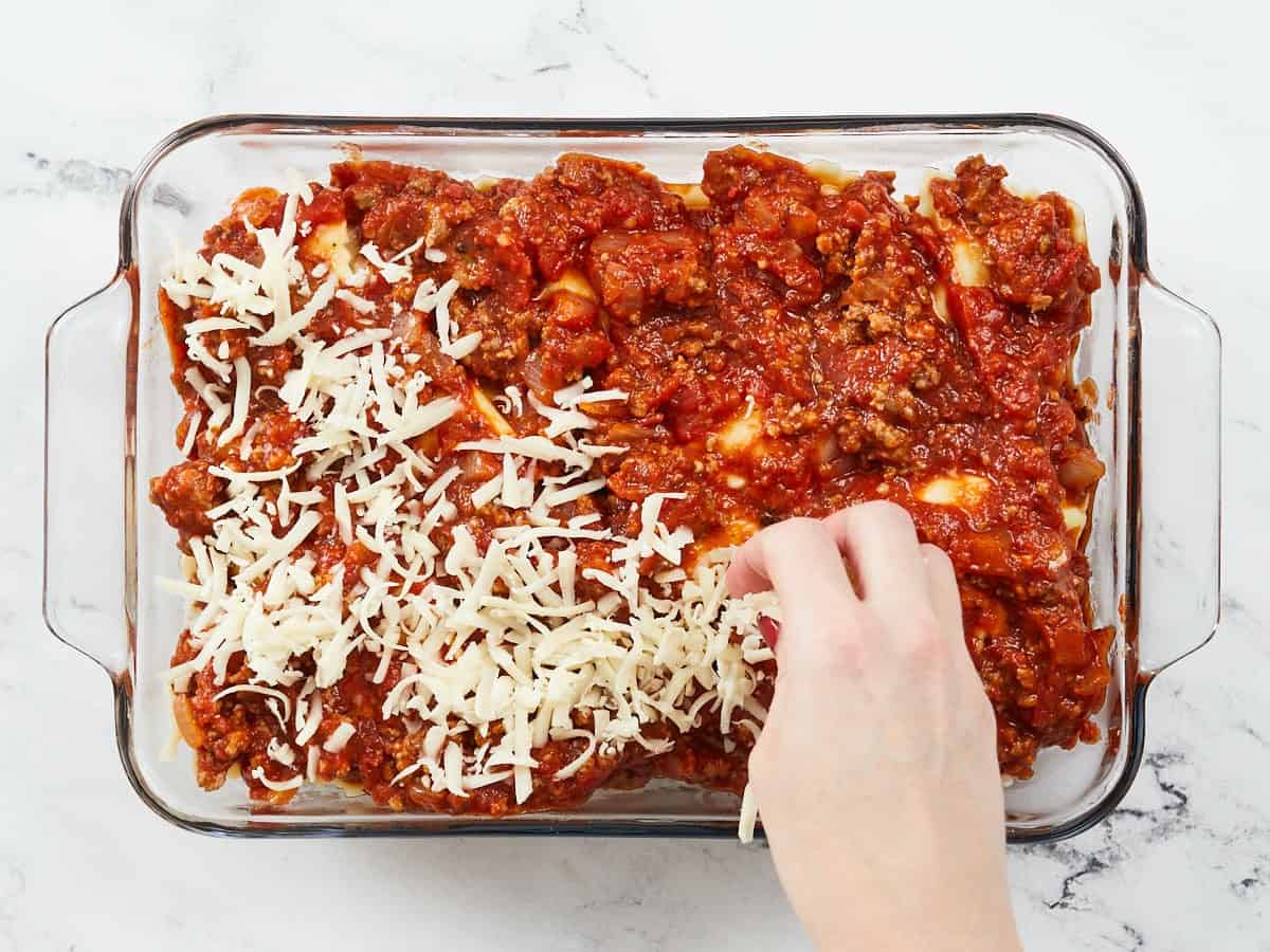 Second layers of sauce, ravioli, and cheese in the casserole dish. 