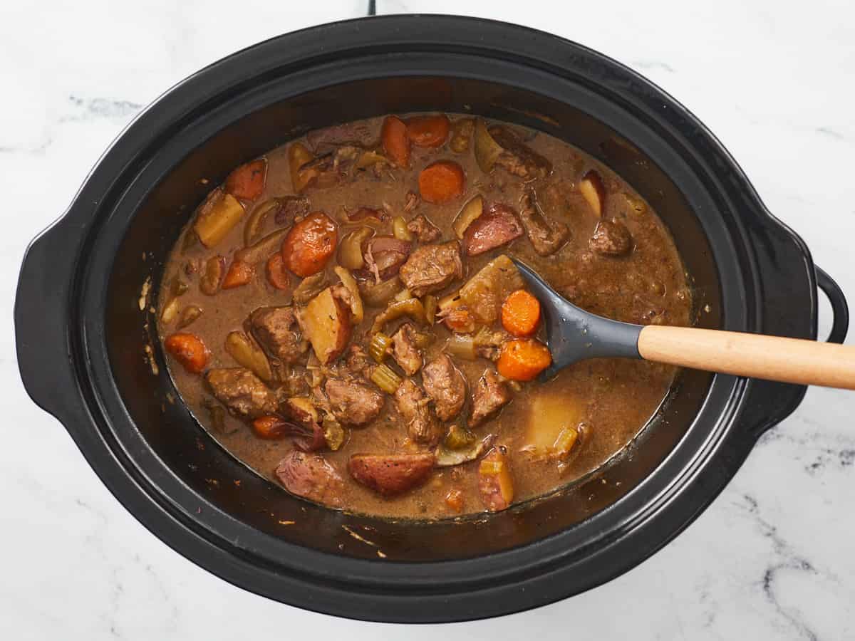Stirred beef stew in the slow cooker.