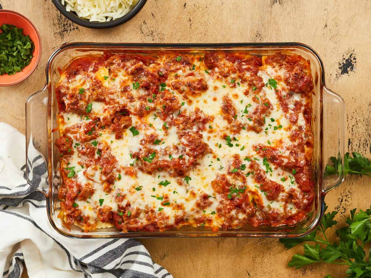 Overhead view of a full pan of baked ravioli.