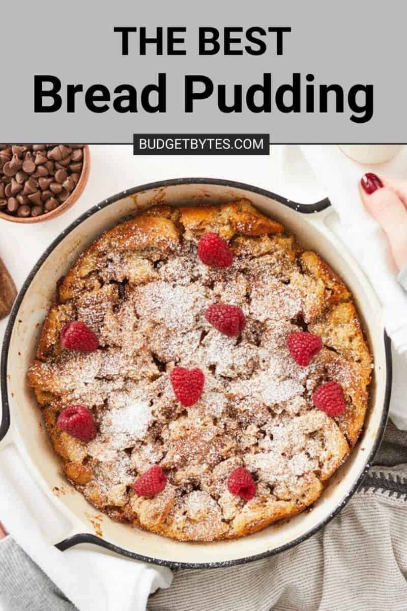 A large overhead image of a bread pudding in a round white baking dish topped with powdered sugar and fresh raspberries under a text box that says the best bread pudding on a gray background.