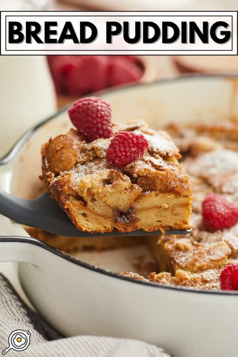 Side view of a slice of bread pudding being lifted out of the baking dish.