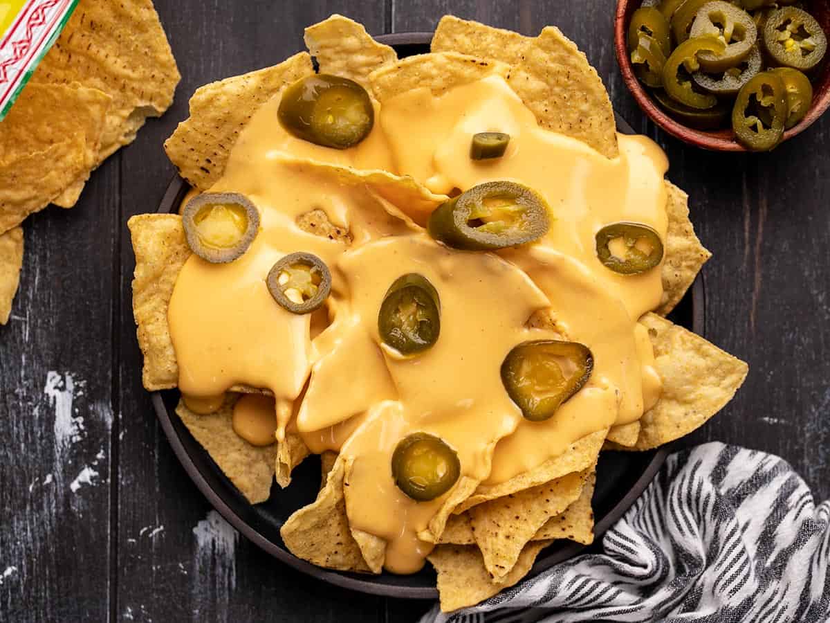 Overhead view of a plate of nachos with jalapeños.