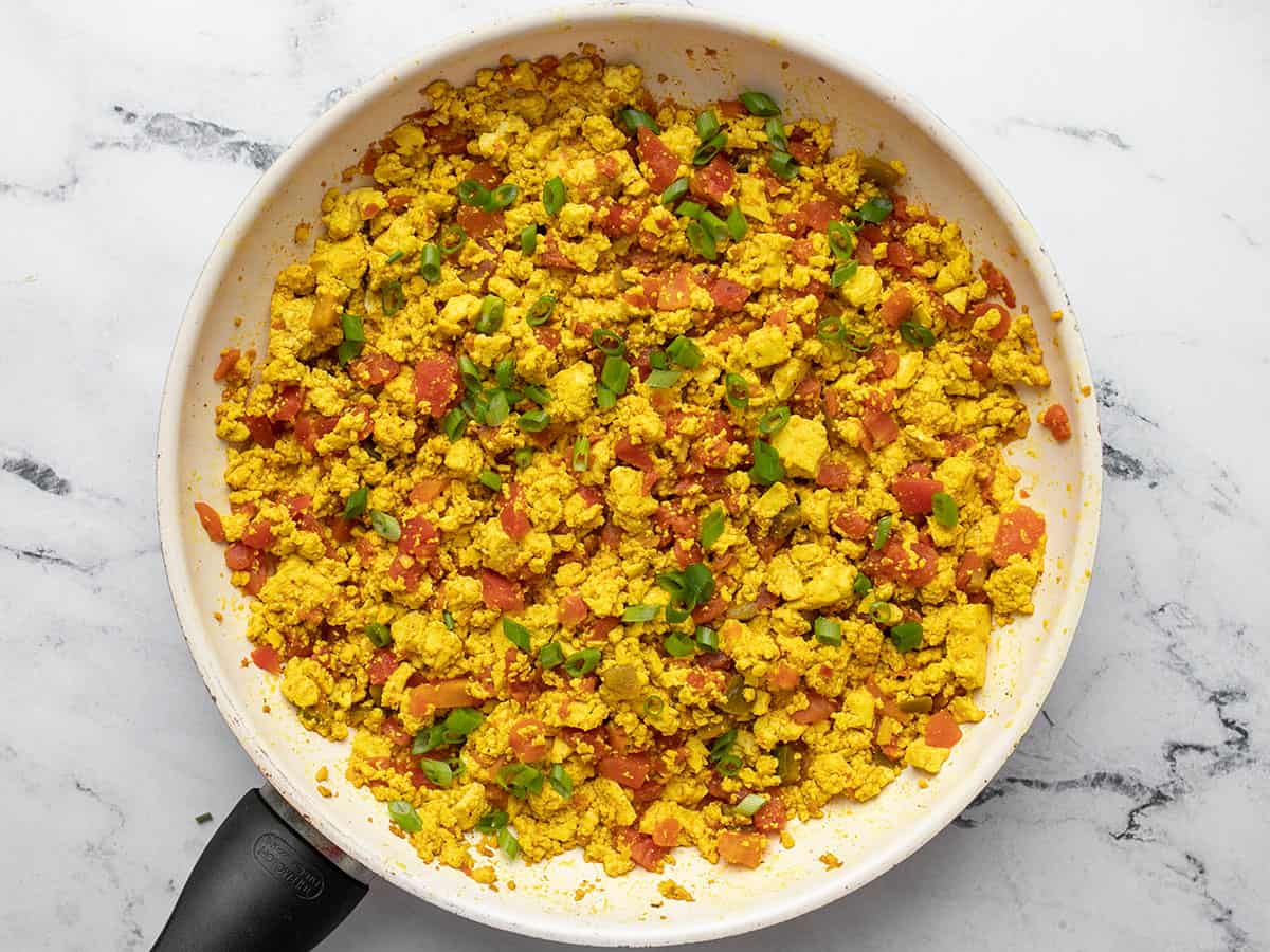 Finished tofu scramble in the skillet with green onions.