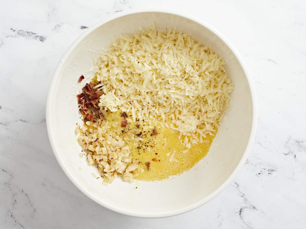 Overhead shot of quiche ingredients in a bowl.