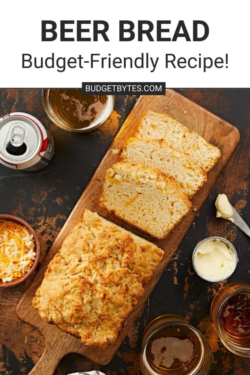 An overhead shot of a half-sliced loaf of beer bread on a wooden cutting board with a white text box and black text above that says, "Beer Bread Budget-Friendly Recipe"
