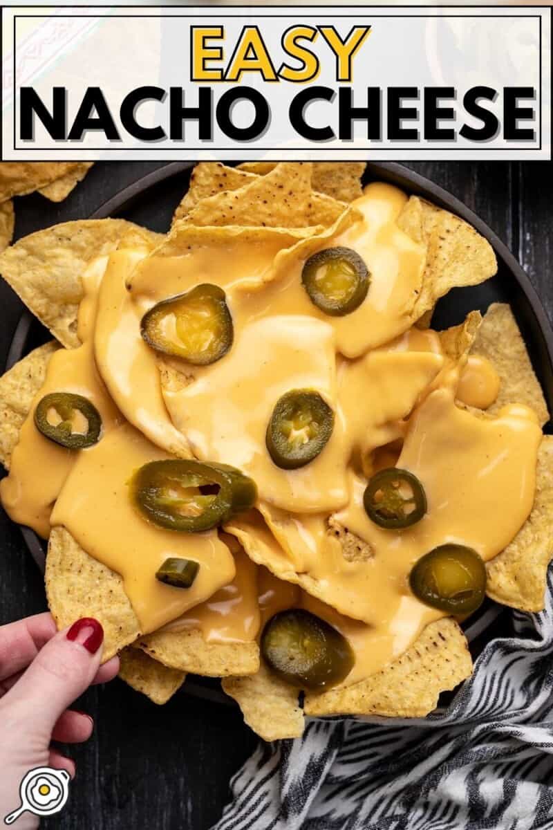 Overhead view of a plate full of nachos with jalapeños.