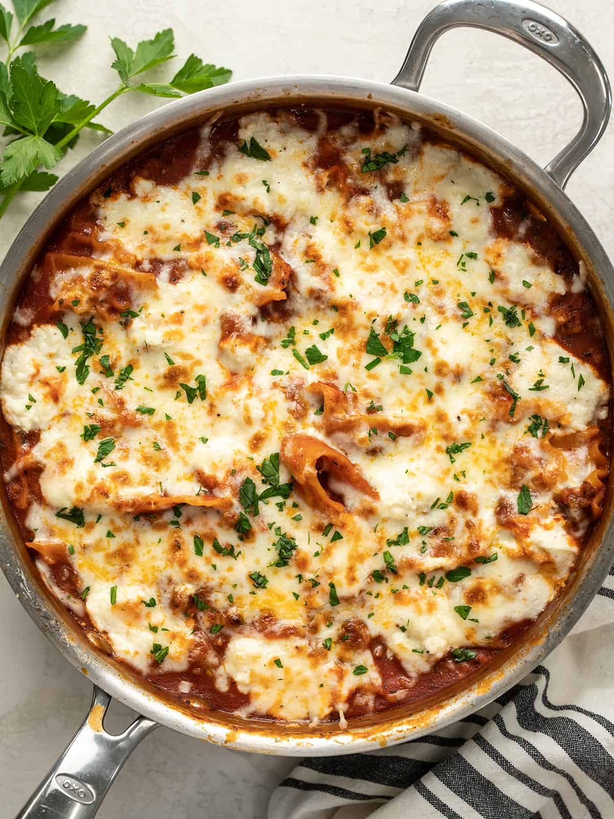 Overhead view of skillet lasagna garnished with parsley.