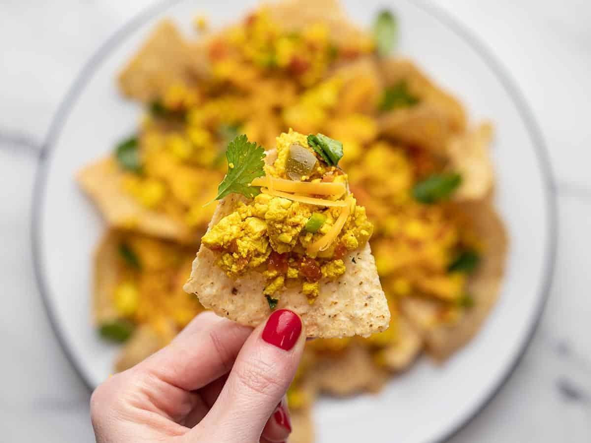 Close up of a chip with tofu scramble on top.