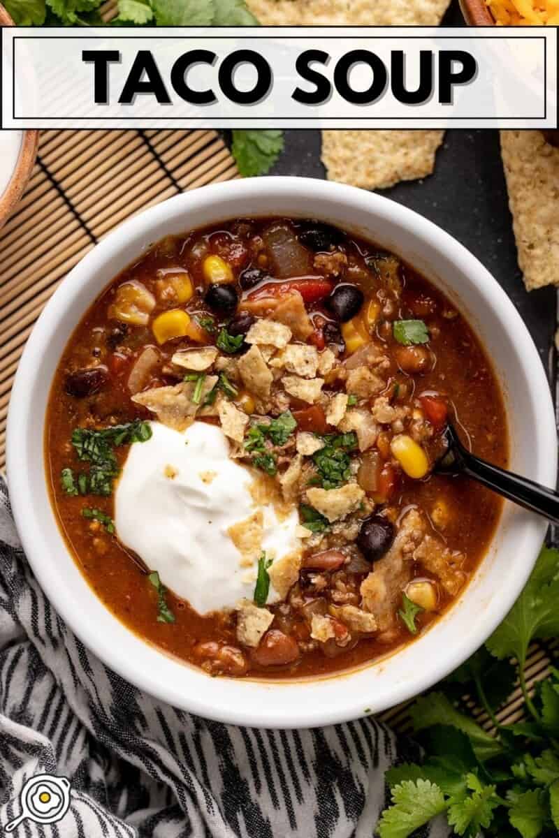 Overhead view of a bowl of taco soup with sour cream.