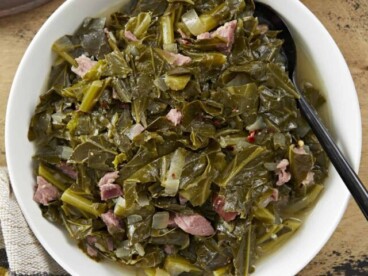 Overhead view of a bowl full of collard greens with ham.