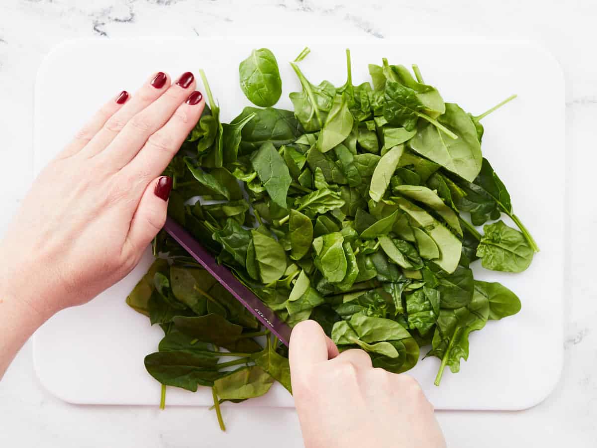 Fresh spinach being chopped.