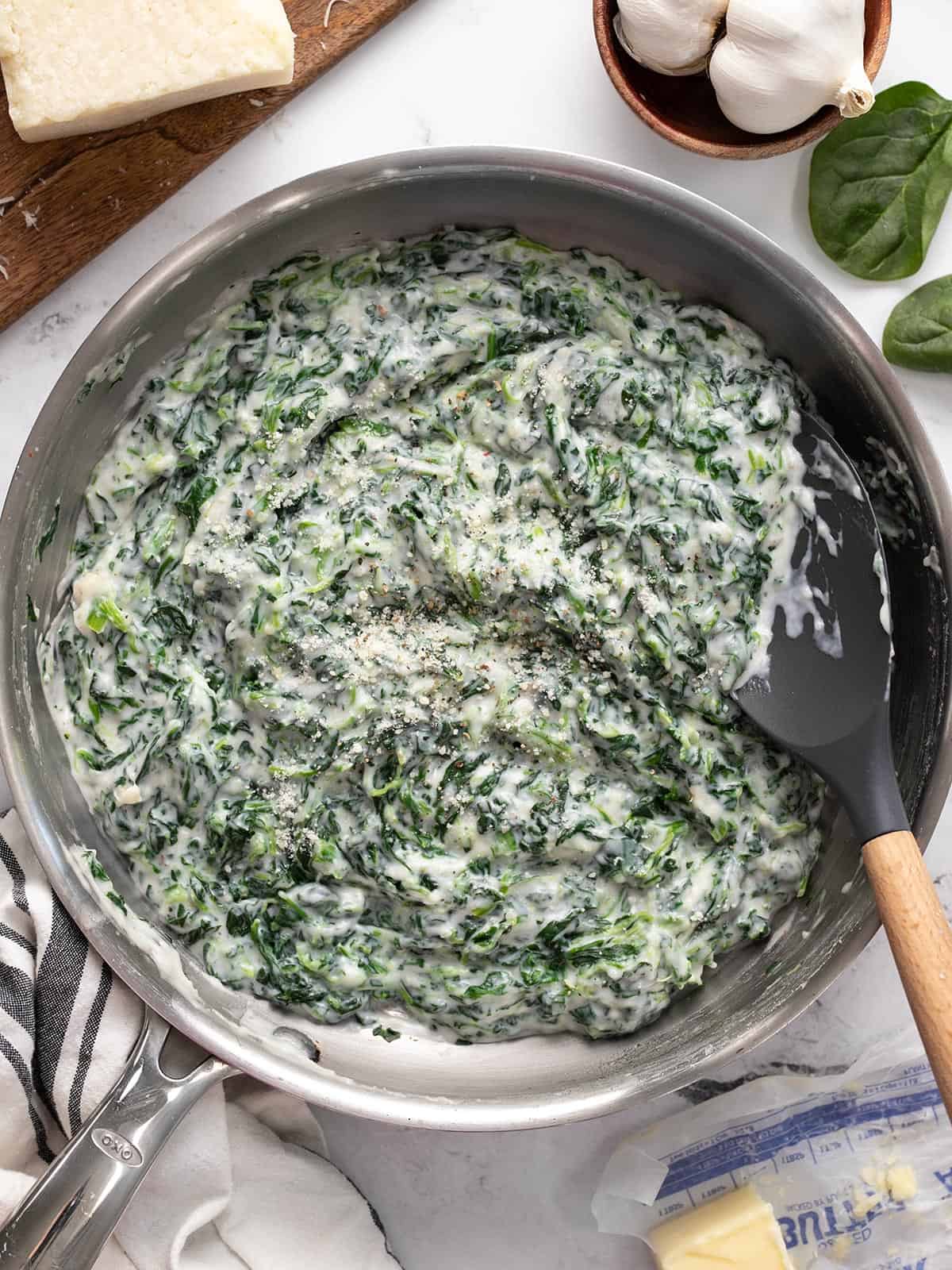 Overhead view of a skillet full of creamed spinach.