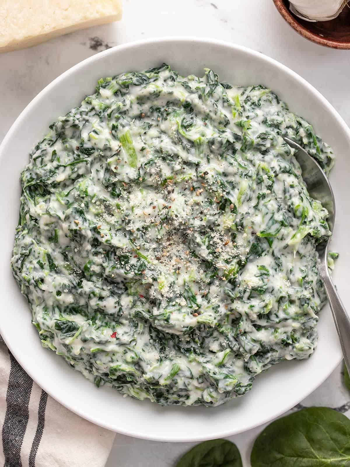 Overhead view of a bowl full of creamed spinach.
