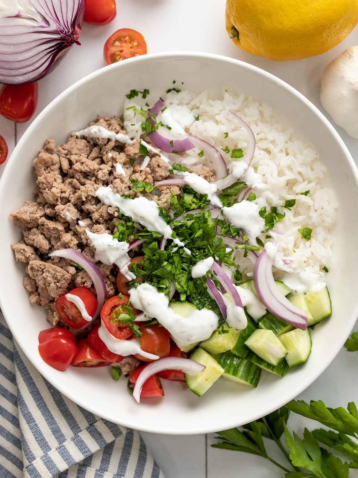 Overhead view of Mediterranean Turkey Bowl with ingredients on the sides.