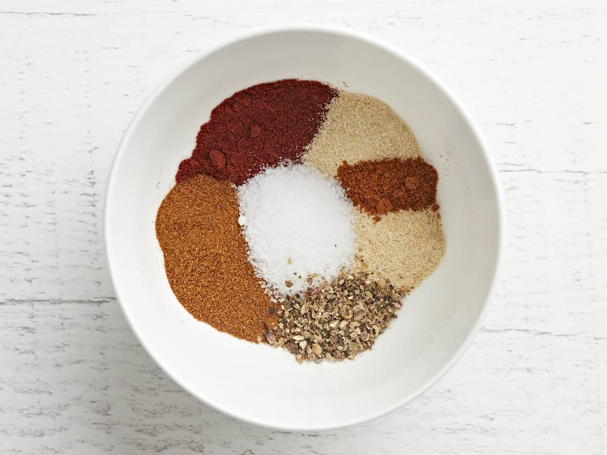 Individual spices in a bowl before stirring.