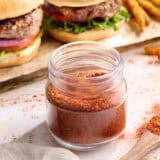 Side view of homemade burger seasoning in a jar.