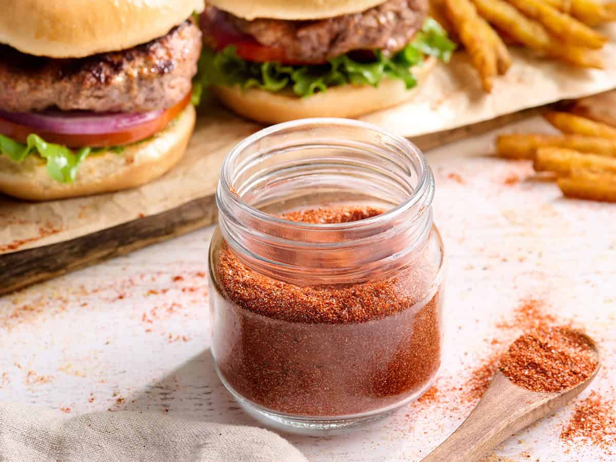 Side view of homemade burger seasoning in a jar.