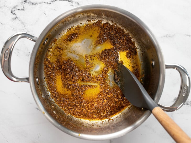 Spices being sautéed with the garlic and oil.