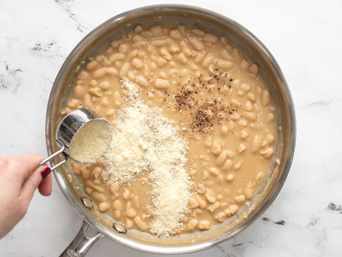 Pepper and Parmesan being added to the skillet.