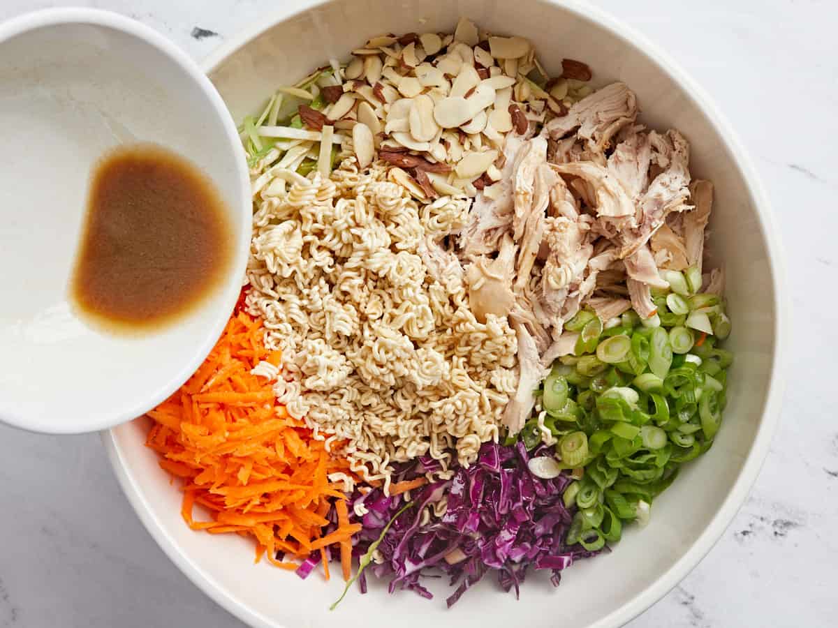 All ingredients for salad being combined in a large bowl. 