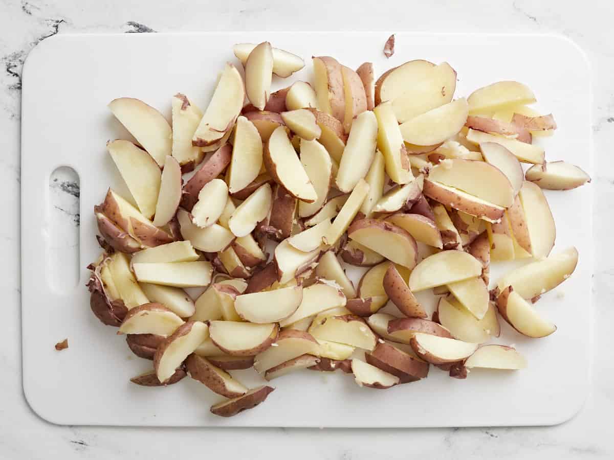 Sliced potatoes on a cutting board.