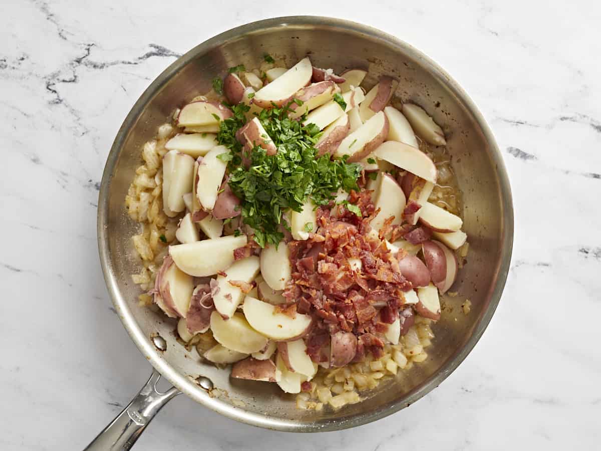 Sliced potatoes, parsley, and bacon added back to the skillet.