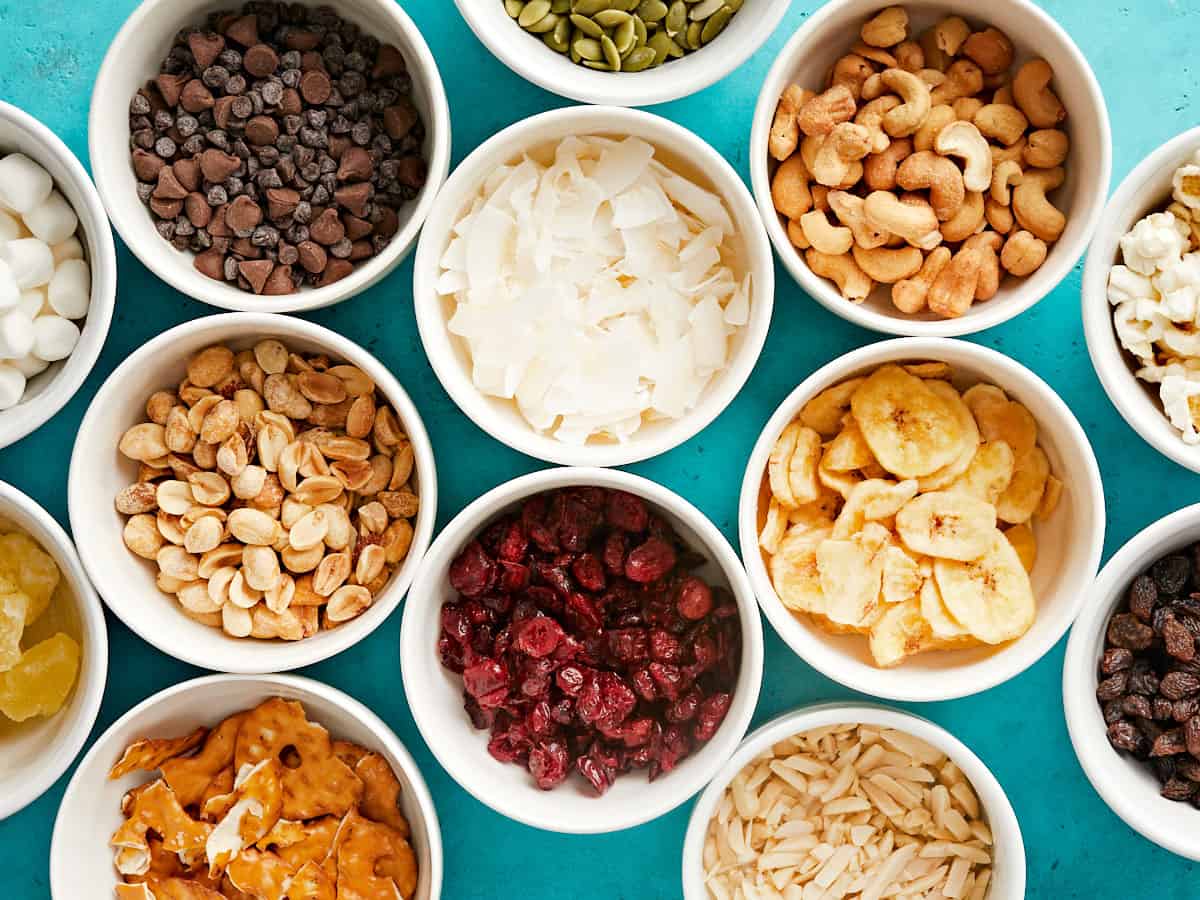 Overhead view of bowls of ingredients for trail mix.