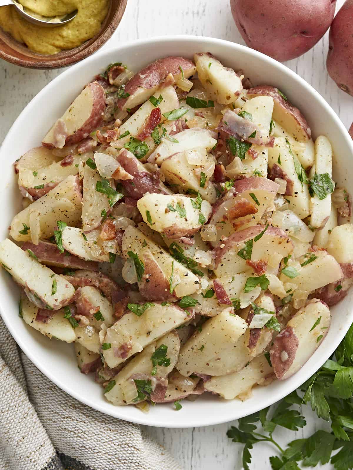 close up overhead view of German potato salad in a bowl. 