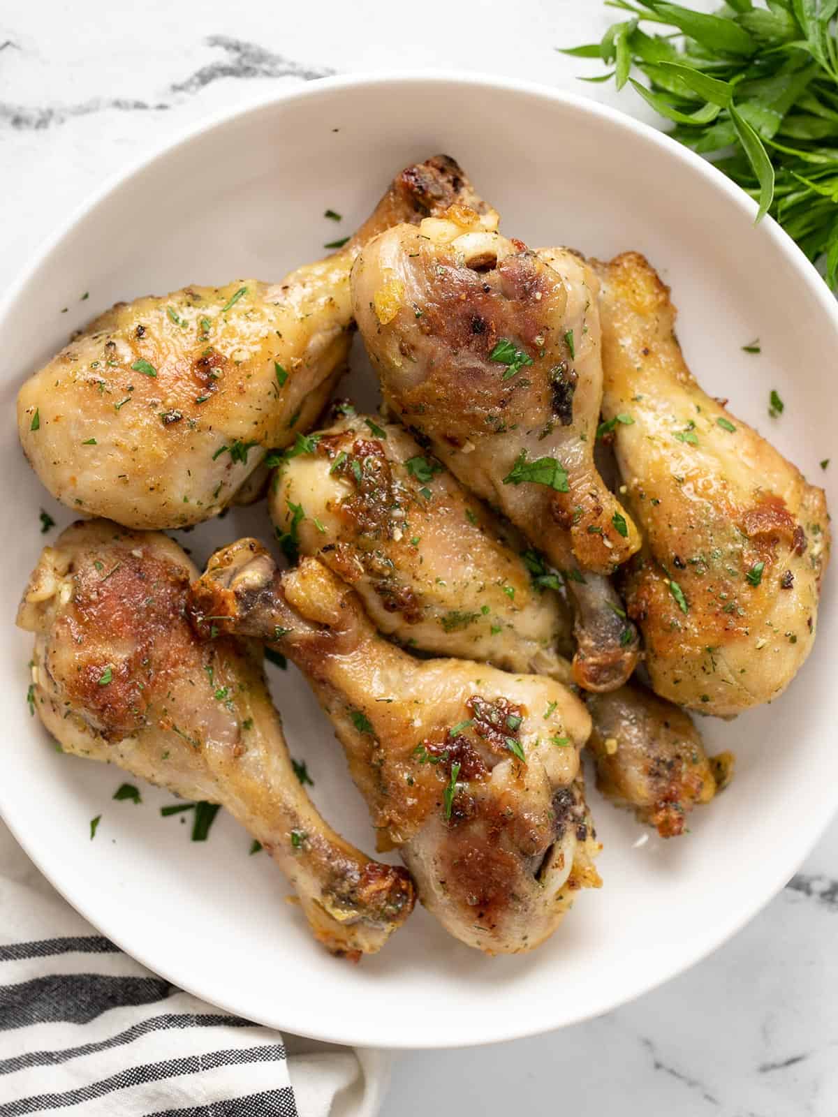 Overhead view of a bowl full of ranch chicken drumsticks.